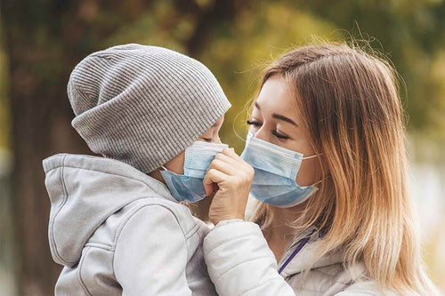 girl-with-child-stands-road-protective-medical-mask-coronovirus