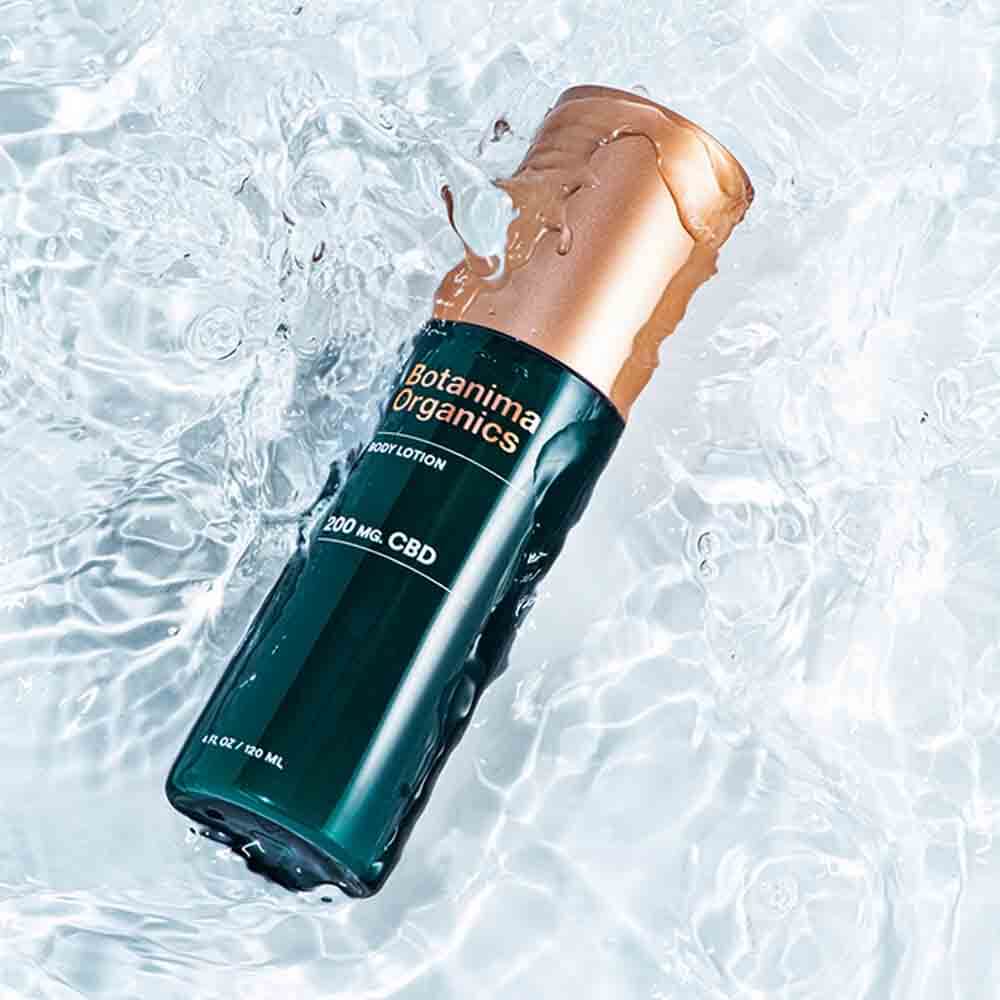 CBD-Body-Lotion-Dark-Green-Bottle-With-Rose-Gold-Cap-in-Water-Premium-Skincare