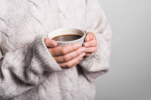 Woman-in-White-Sweater-Holding-a-Cup-of-Coffee